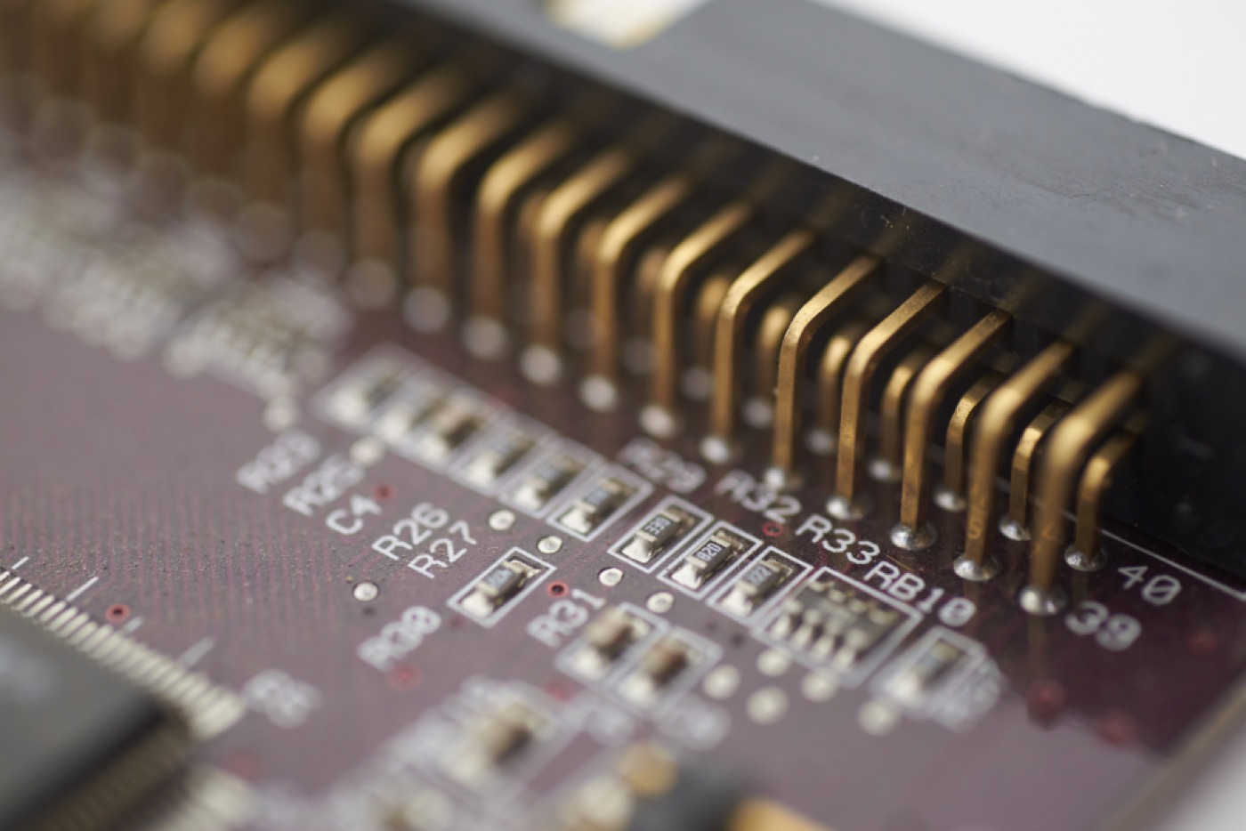 Close-up of gold connector pins and components on a circuit board.
